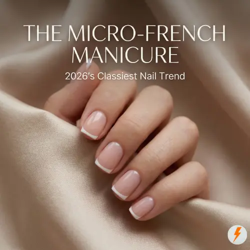Close-up of a woman’s hand featuring a minimalist Micro French Manicure on short squoval nails with a sheer nude base and razor-thin white tips. The image includes text overlay reading "THE MICRO-FRENCH MANICURE: 2026’s Classiest Nail Trend" against a soft beige silk background.